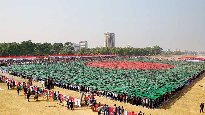 A staggering 27,117 people stand united, holding green and red boards above their heads, to put up the world’s biggest ever human flag at the National Parade Ground on Victory day yesterday